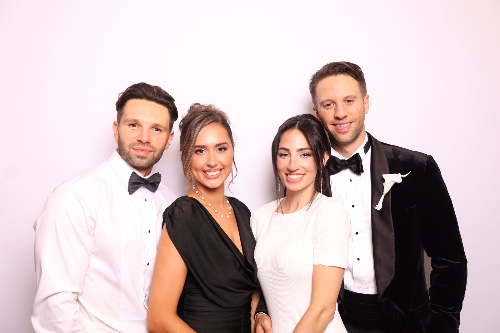 Wedding guests in black tie posing for a studio-quality booth photo
