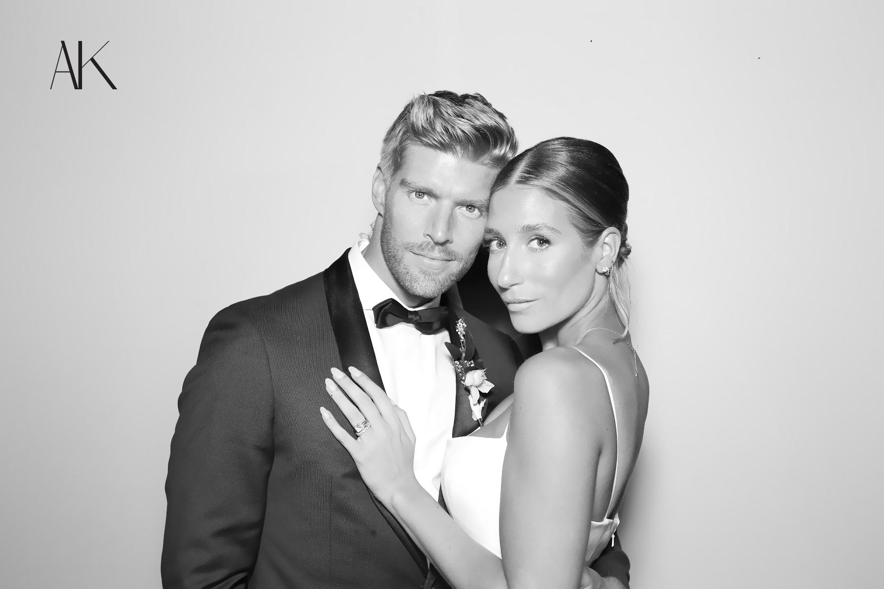 A couple in formalwear posing for a black-and-white Glam Booth portrait